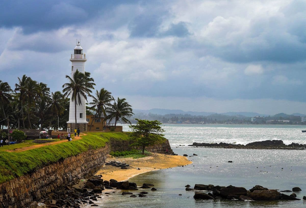 Galle Fort lighthouse with palm trees on the southern coast of Sri Lanka