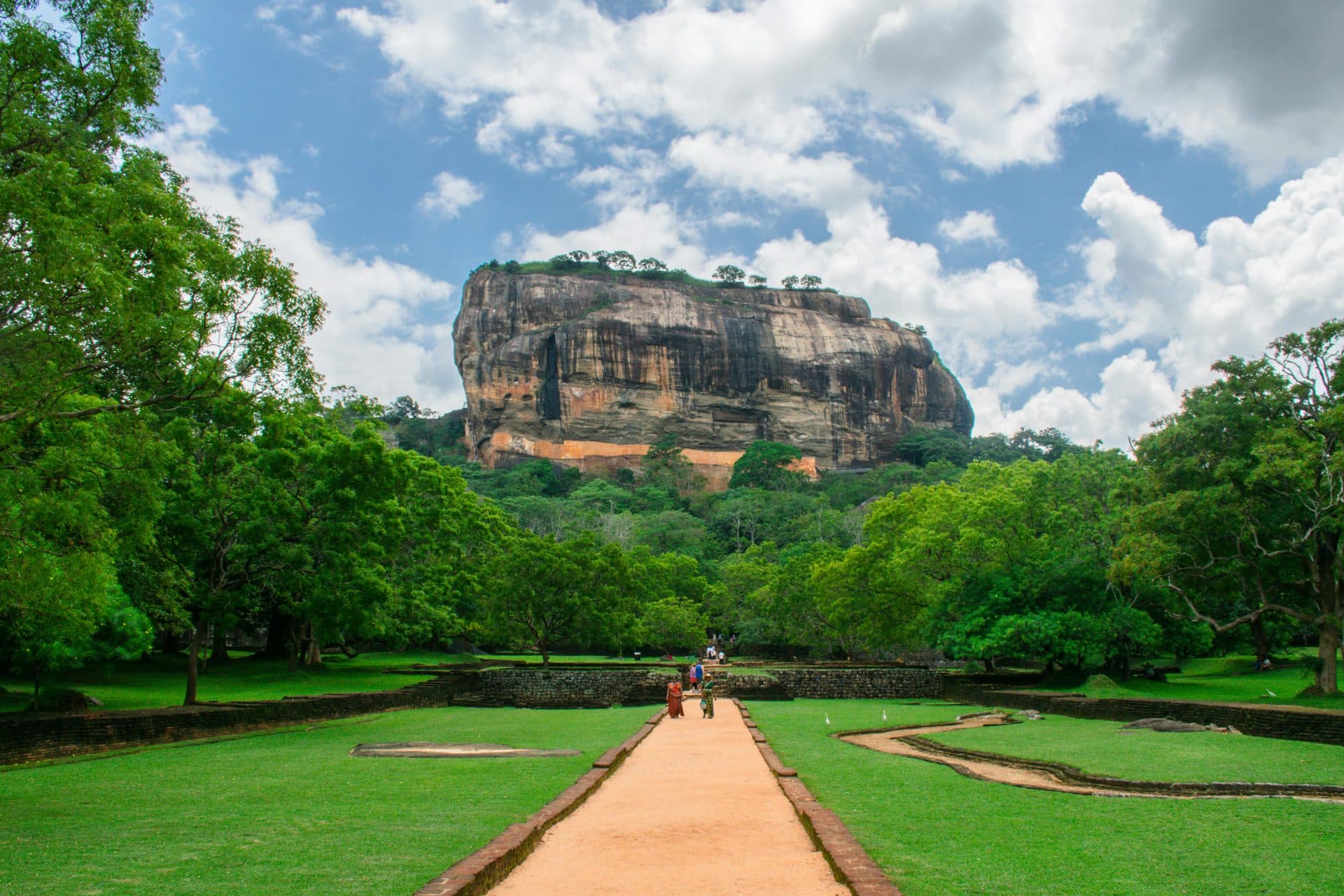 Sigiriya Lion Rock fortress with lush green gardens and pathways leading to the ancient rock, Sri Lanka